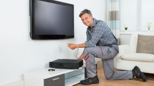 man kneeling and installing DStv
