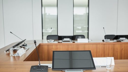 Team collaborating on interactive screens during a corporate presentation in a modern boardroom
