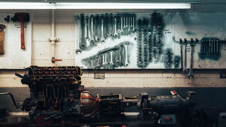 Air compressor powering pneumatic tools in a workshop