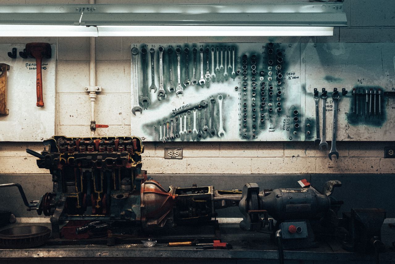 Air compressor powering pneumatic tools in a workshop